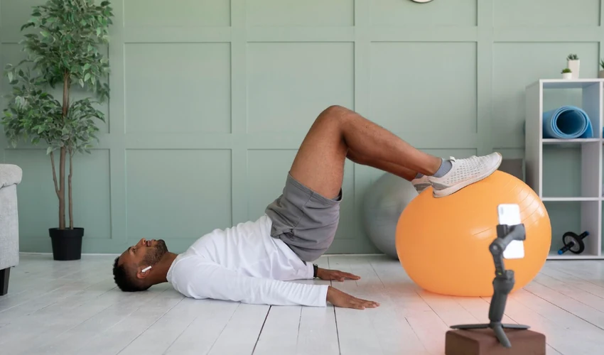 Man performing a stability ball exercise as part of an active recovery routine