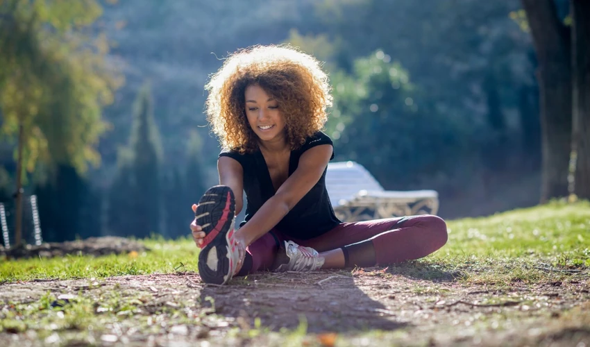 Woman stretching outdoors to support movement and energy